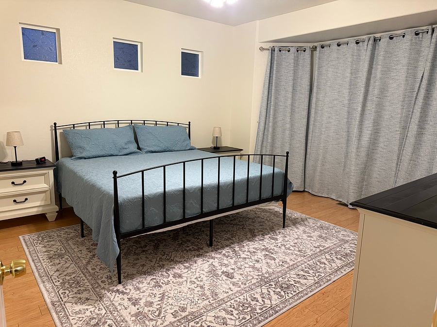 Primary Bedroom with King sized bed and large Bay Windows