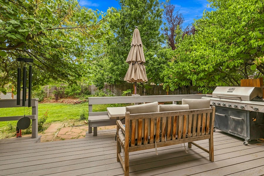 Spacious main deck with shade, an umbrella, and a 6-burner grill for wonderful outdoor meals and relaxing.