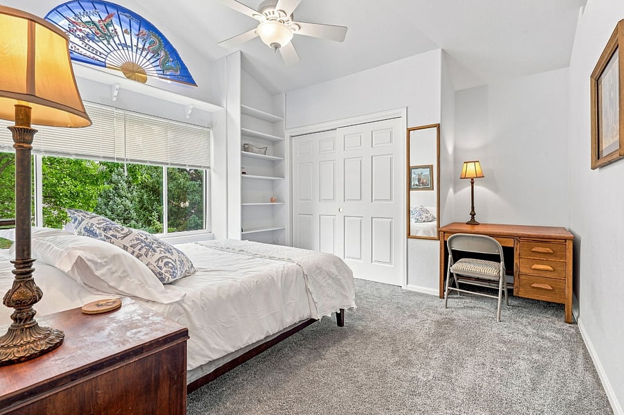 Bedroom 2 (upper floor): large closet, shelf space, and a built-in desk.