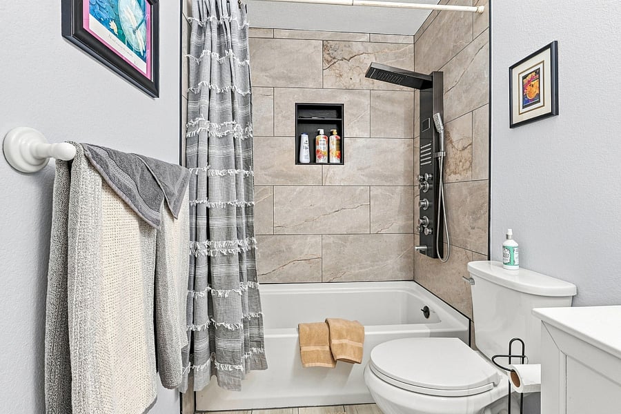 Bathroom (Upstairs directly next to bedroom 2 and bedroom 3): Beautifully tiled and updated for your comfort.