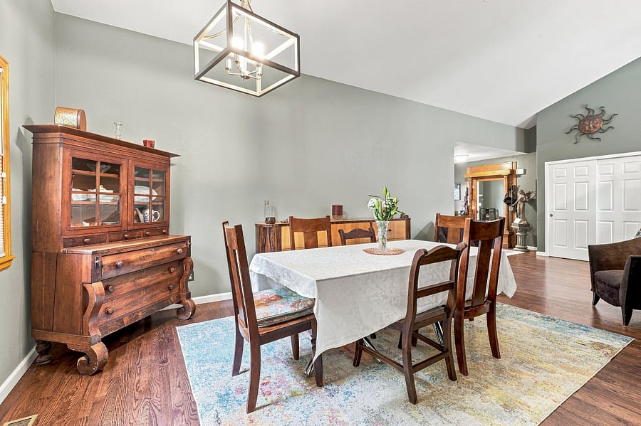 Living room and dining room (main floor): a beautiful dining room with a mix of antiques and hand-built furniture, large enough for dinner parties.