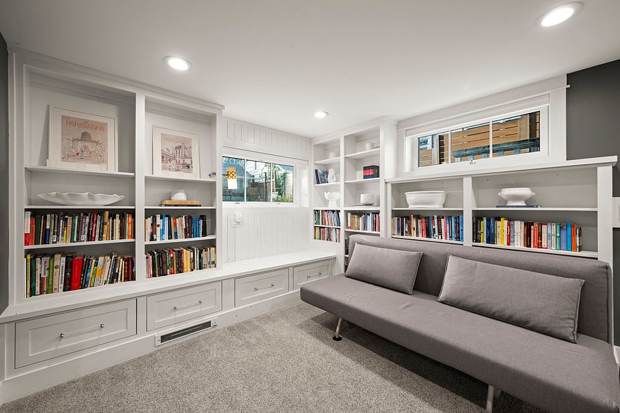 Book shelves, convertible modern couch that can fold down into queen couch-bed.