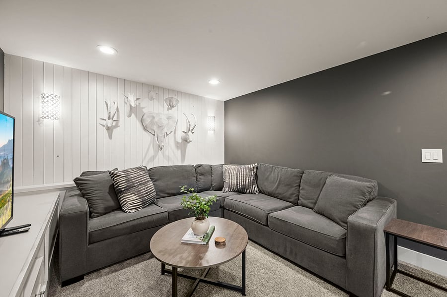 Another view of sectional seating area by TV and mural wall in the main lounge.