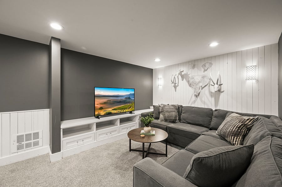 Closer view of sectional seating area by TV and mural wall in the main lounge.