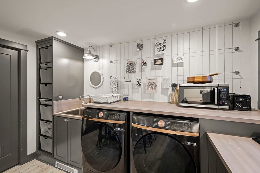 Appliance close-up showing microwave, cooktop area, laundry units, and adjacent counter space.