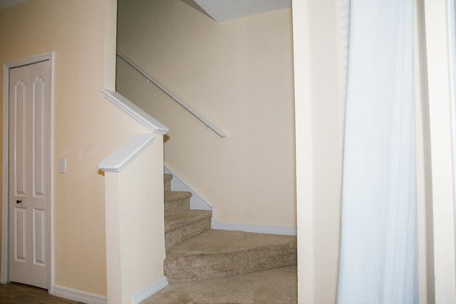 Stairs off the kitchen leading up to the Primary and Secondary Bedrooms