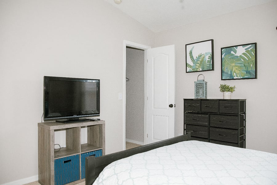 Secondary bedroom; 2 storage units, TV with a fire stick, and a walk-in closet