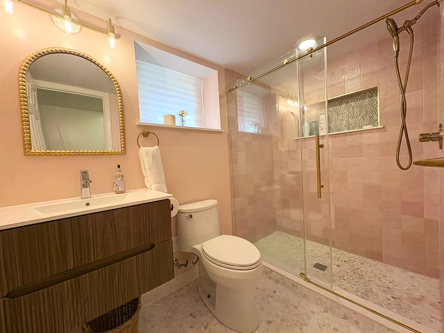 UNIT 2: 1 Marble & Pink Bathroom with a standing shower, toilet and a vanity.