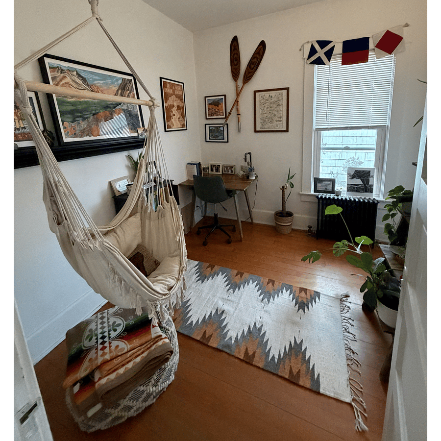 Warm office area with desk and hanging chair/ottoman perfect for reading on lazy weekends