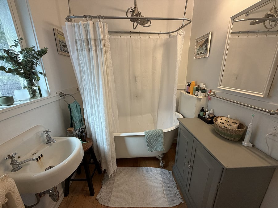 Relaxing bathroom setting with luxurious clawfoot tub - towels included!