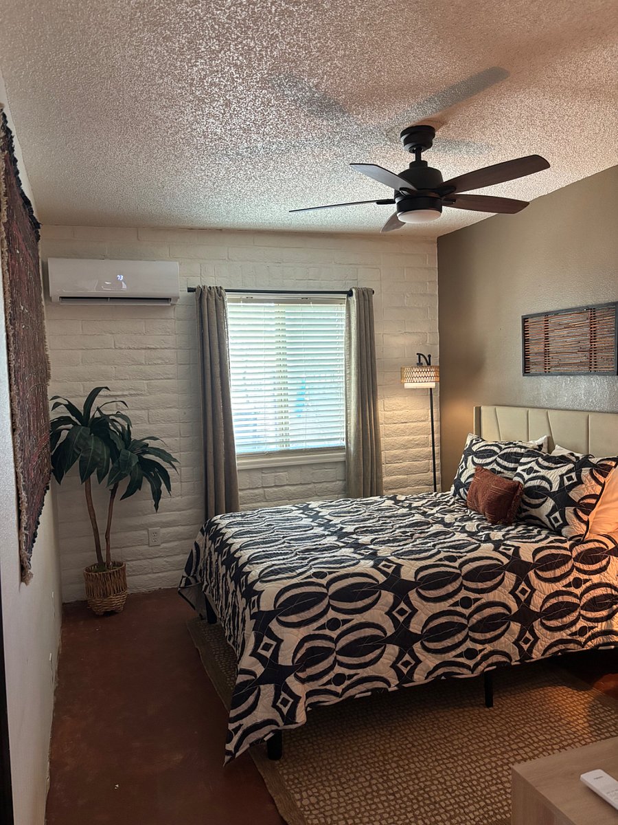 comfortable queen bed with extra sheets, blanket, bedspread, dresser, and closet.