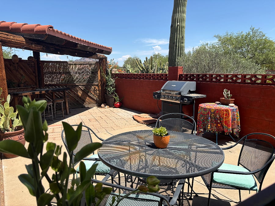 Shared outdoor cantina with barbeque and seating areas.