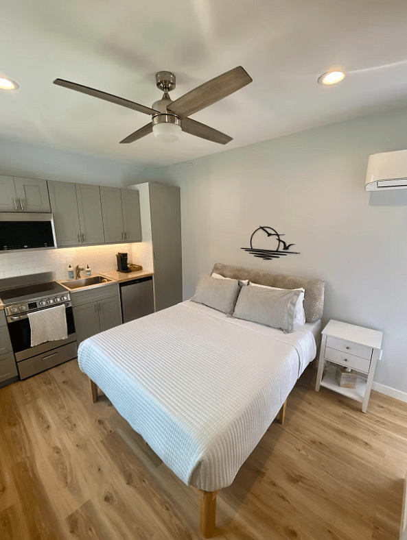 Queen bed with linens.