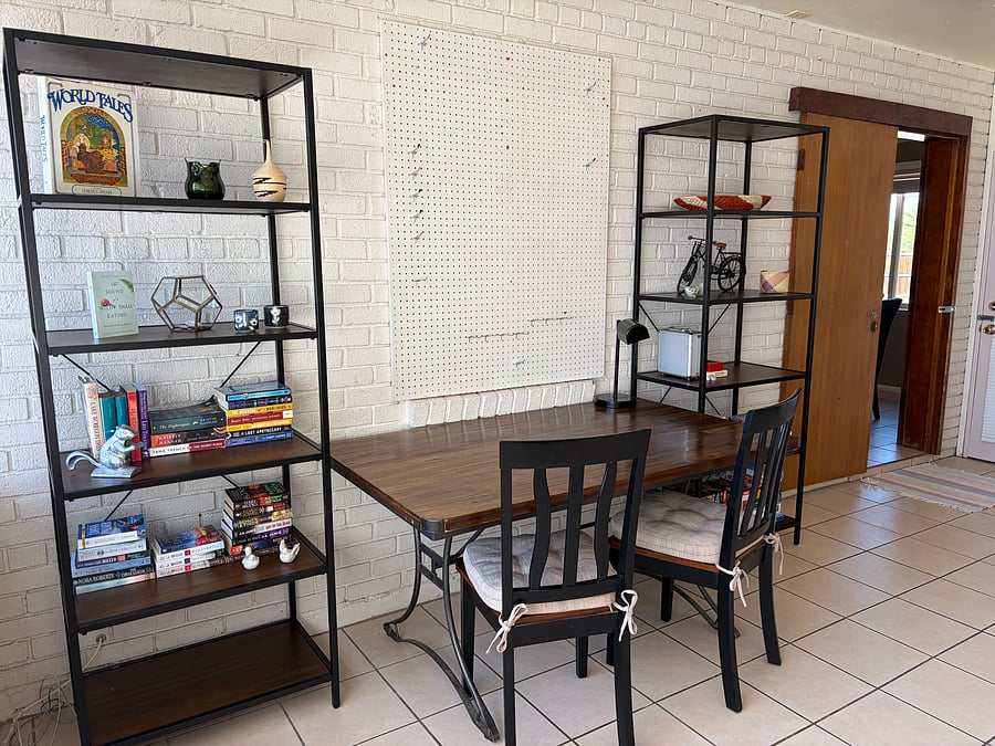 Activity room with puzzle/game table, bookshelves (stocked with variety of books, puzzles, and games).