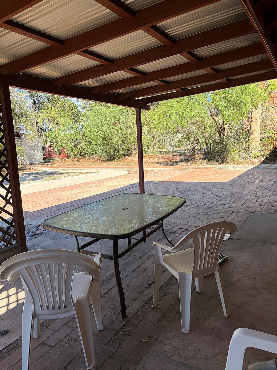 Back patio with glass table and four chairs
