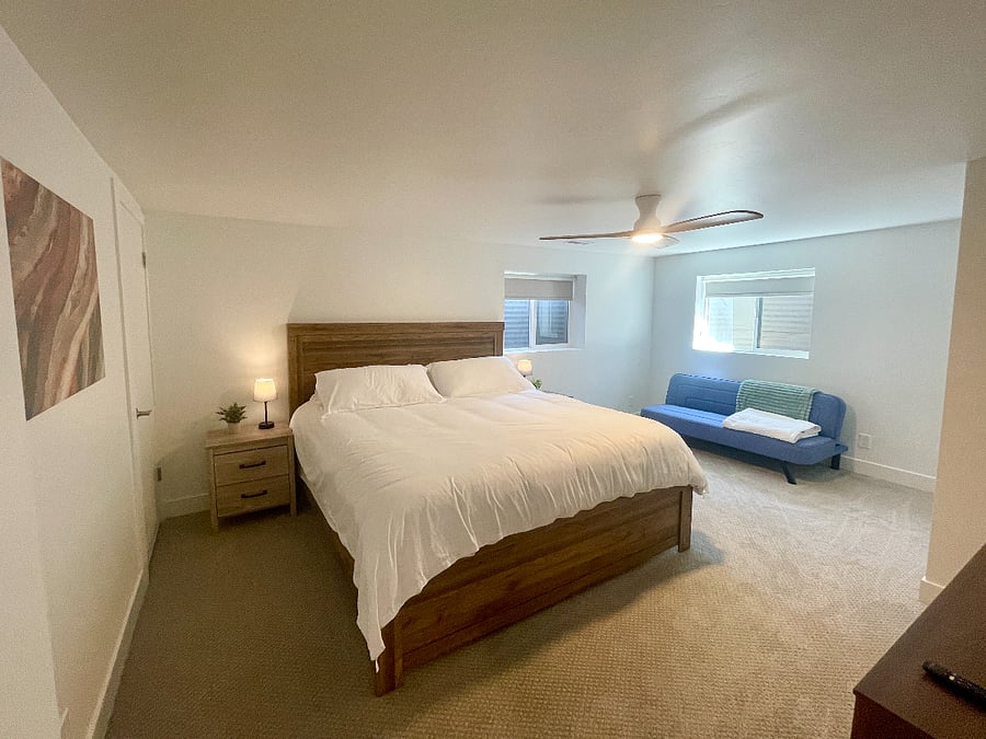 Large bedroom with king bed, spacious closet, TV, and futon.