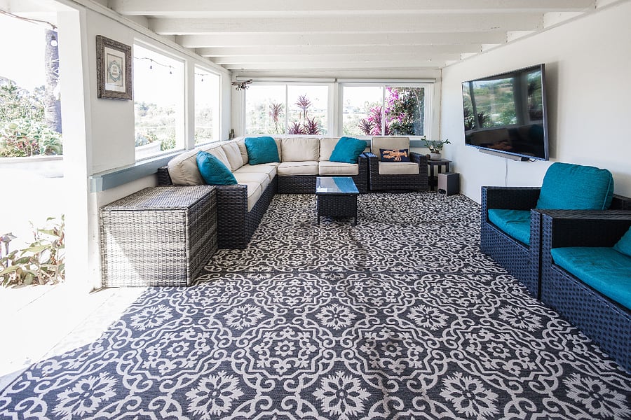 Indoor-outdoor California room with wall-mounted 75" TV