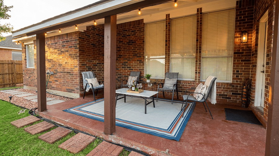 Calming outdoor patio ideal for unwinding after long shifts comfortable seating, soft lighting, and a peaceful backyard view.