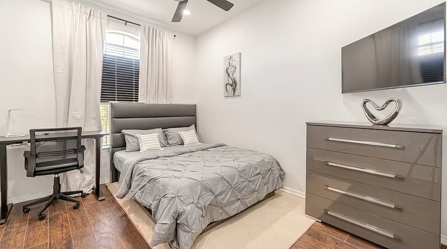 Hybrid bedroom featuring a QUEEN bed, dedicated workspace, natural light, and modern décor - ideal for remote work and long-term stays.