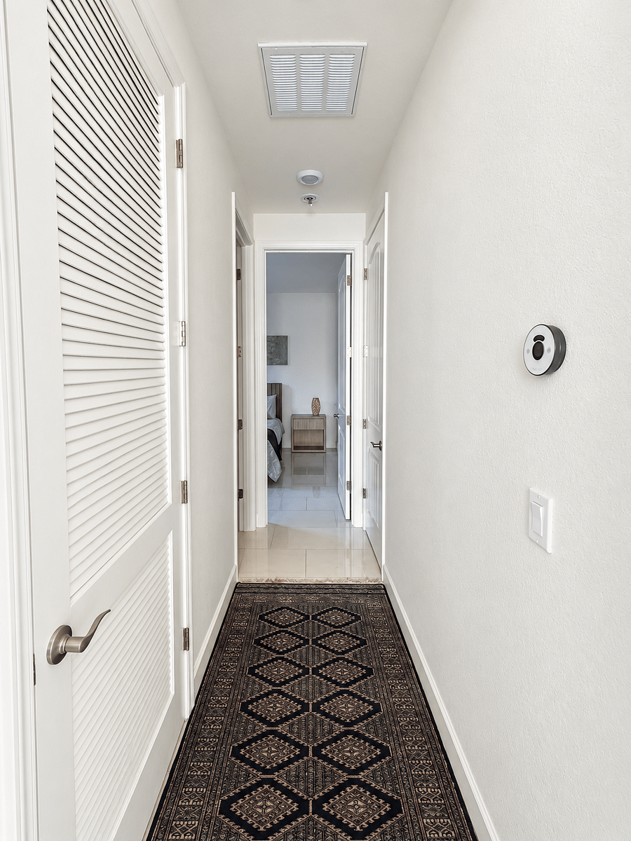 Private hallway connecting the living area to the bedroom, bathroom, and in-unit laundry.
