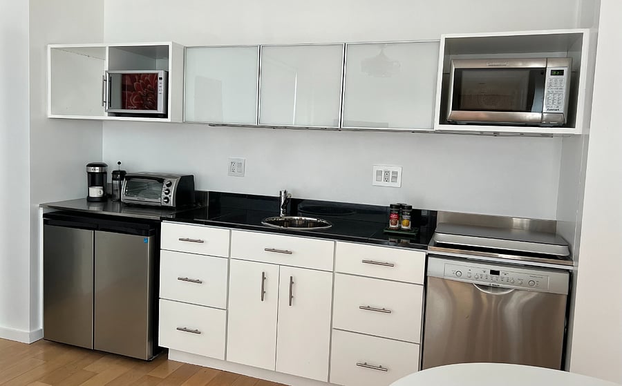 Kitchenette (multifunctional storage, a microwaveconvection oven, induction cooktop, compact refrigerator/freezer, beverage cooler, countertop toaster oven, dishwasher)