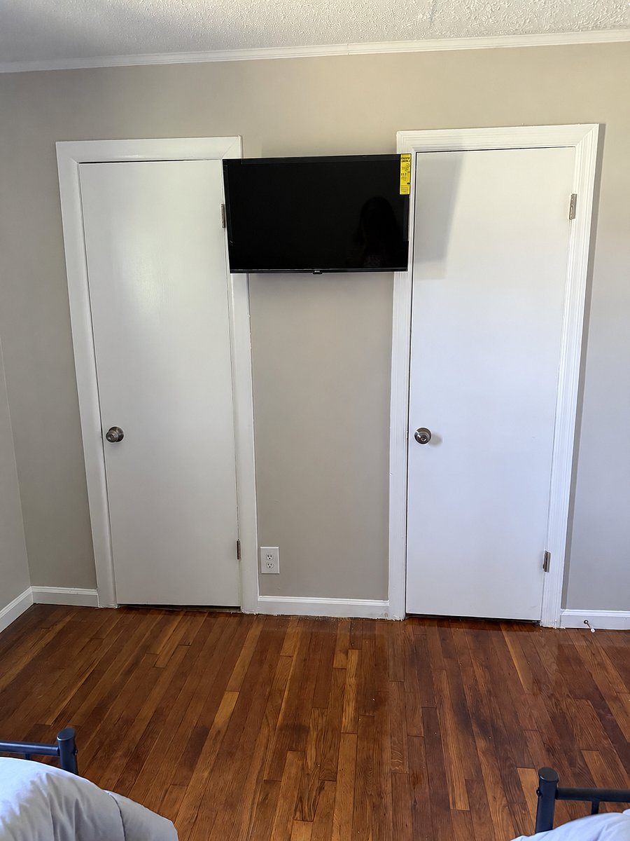 Closets in room with twin bed