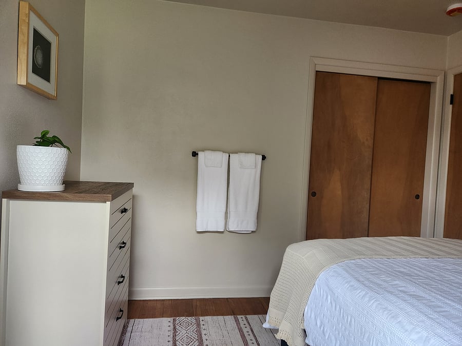 Bedroom 2 (closet includes extra sheets, blanket, hamper, wood hangers, and luggage rack)