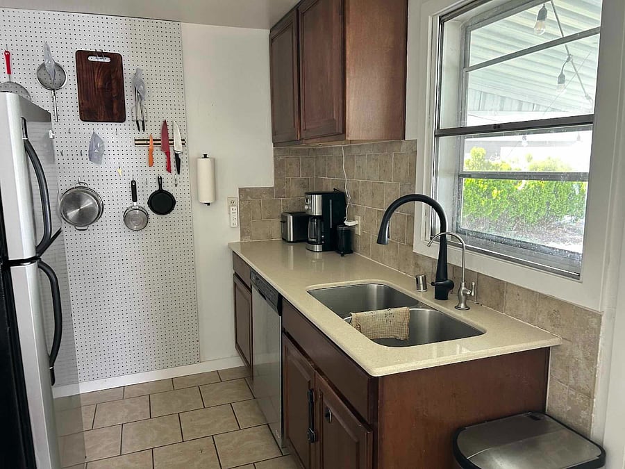 Furnished Kitchen with dishwasher, electric range, microwave, refrigerator, toaster, coffee machine, grinder, blender, pots, pans, cutlery, knives, utensils, and dishes. Plus handwashing tools and basic cleaning supplies.