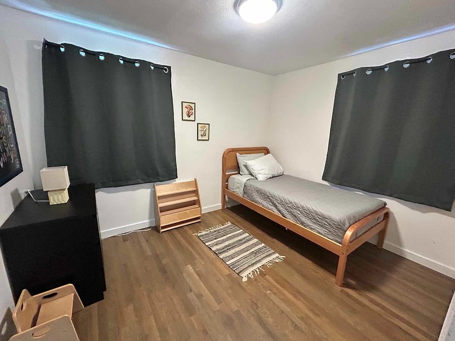 Smaller bedroom with individual size bed, 3 deep drawer dresser, black out curtains, small lamp, closet organizer and hangers included. Also toddler chair for your kiddo