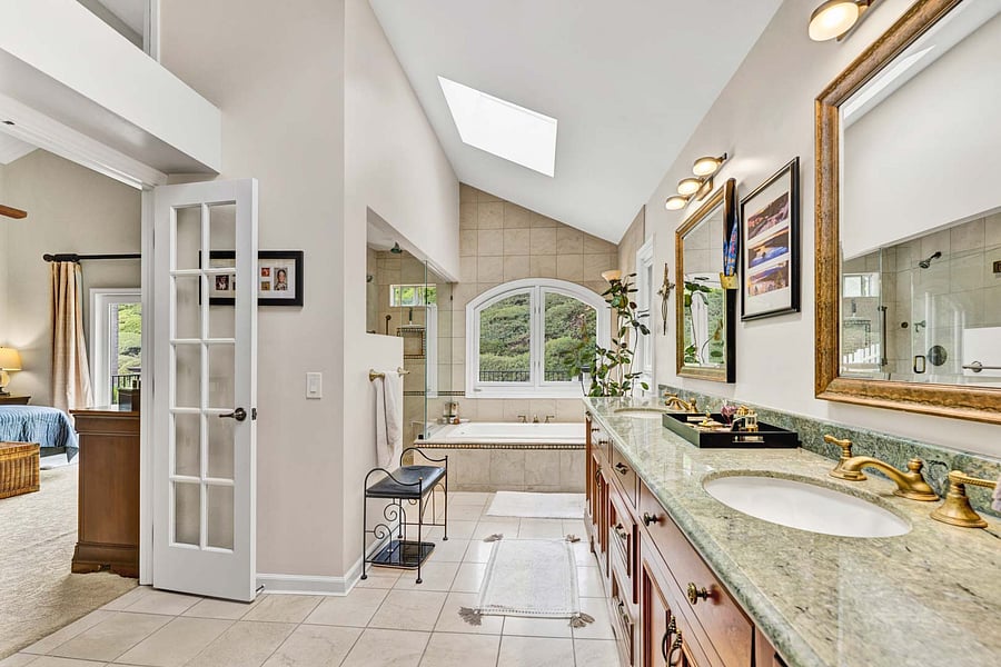 Completely custom Master Bath, high ceilings, skylights, hers and hers sinks, vanity lighting, tile floors...Wow.