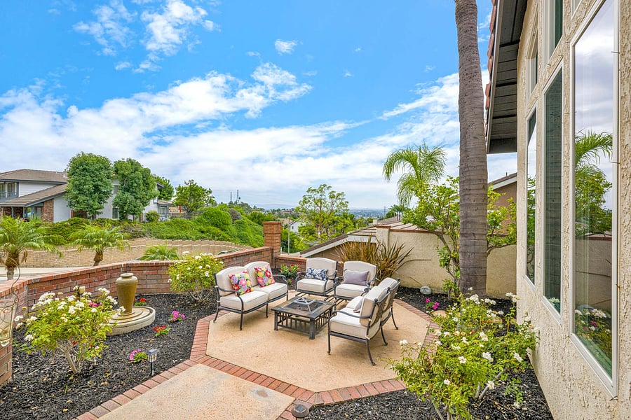 Nice Southwest facing view of Irvine and Orange, custom fire pit area, colorful flowers & Roses, a fruit producing Lemon Tree and all accented by the bubbling fountain, and seating area, NICE!