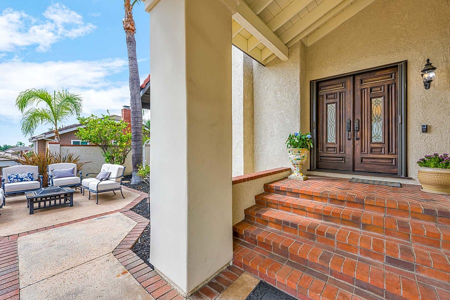 Custom Front Door, Lead Glass inserts, vaulted high ceiling, and custom brick entryway accented by Star Jasmines.