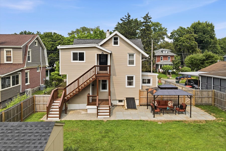 Fully fenced-in back yard with patio and covered pergola.
