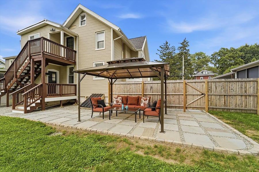 Fully fenced-in back yard with patio and covered pergola.