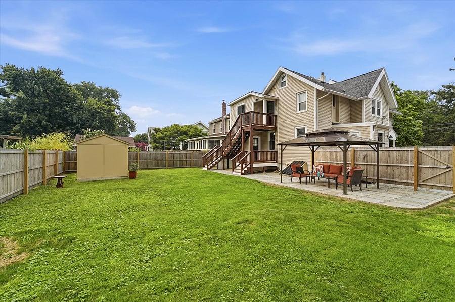Fully fenced-in back yard with patio and covered pergola.