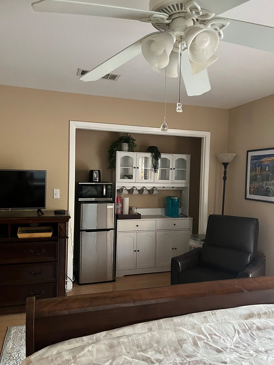 Kitchenette with Keurig coffee station, fridge with freezer, microwave, and toaster.  Also, has some mugs, plates, bowls, and utensils.