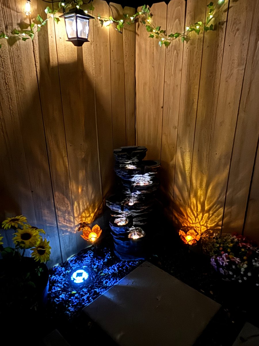 Solar Zen fountain lit up at night.