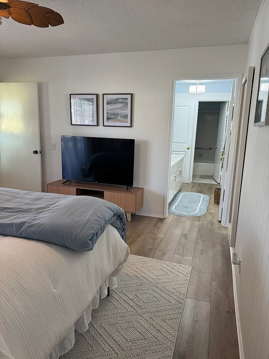 Master bedroom with king bed, smart TV, down comforters and pillows, as well as down alternative comforters and pillows.