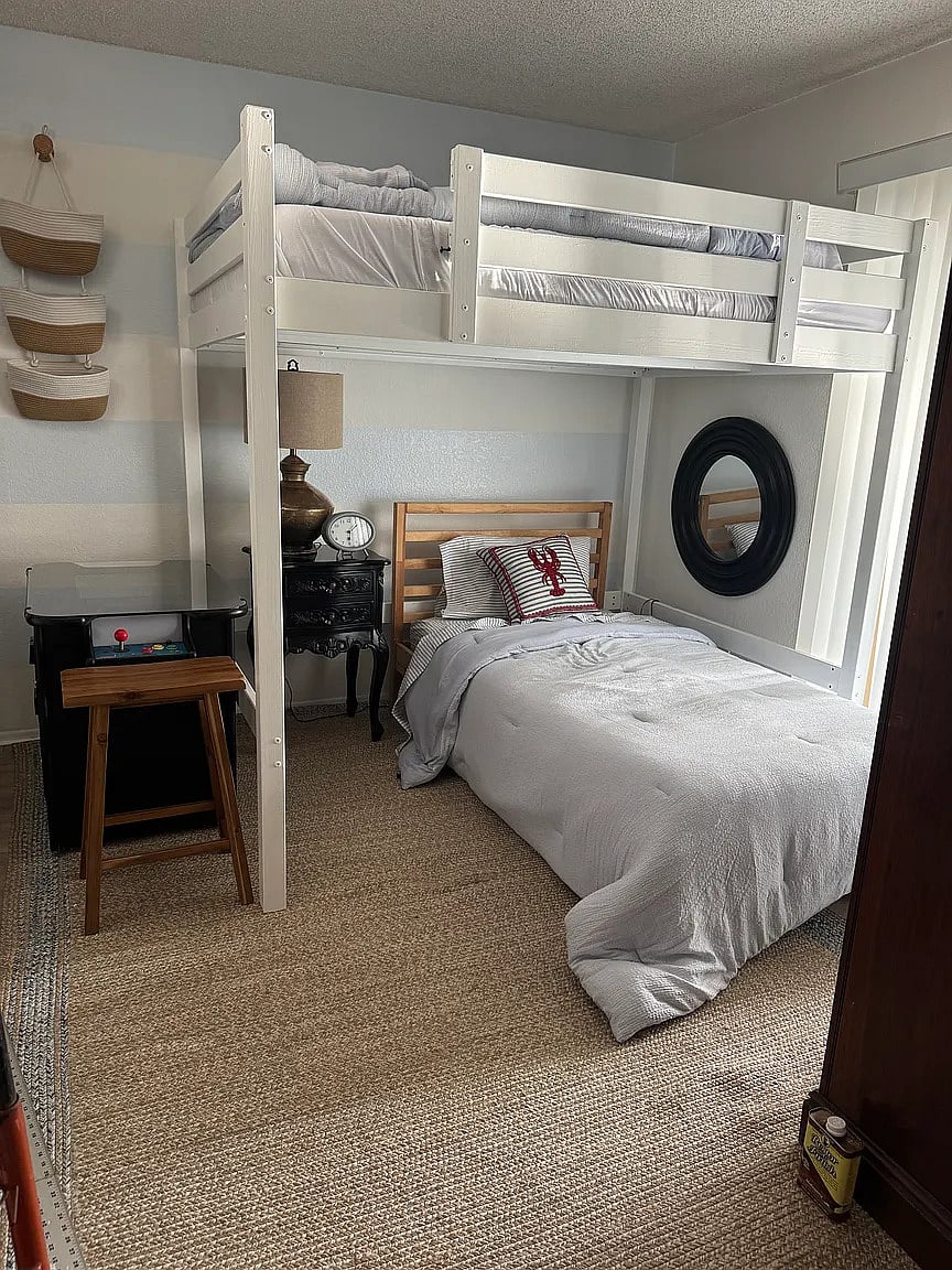 Third bedroom with full loft bed, twin bed, reading nook, and armoire. Enjoy playing video games on the video cocktail table!