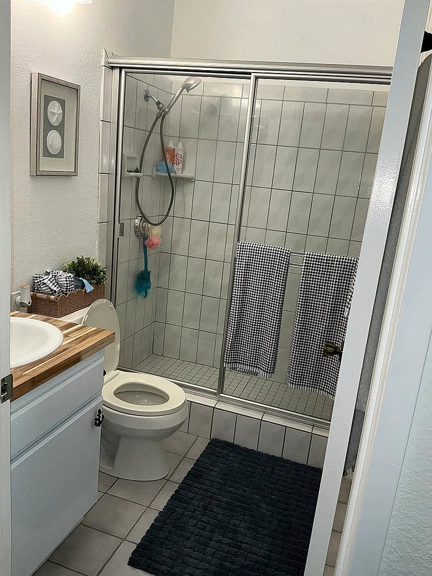 Front Bathroom supplied with shampoo, conditioner, body wash, tooth brushes, brush, and blow dryer.
