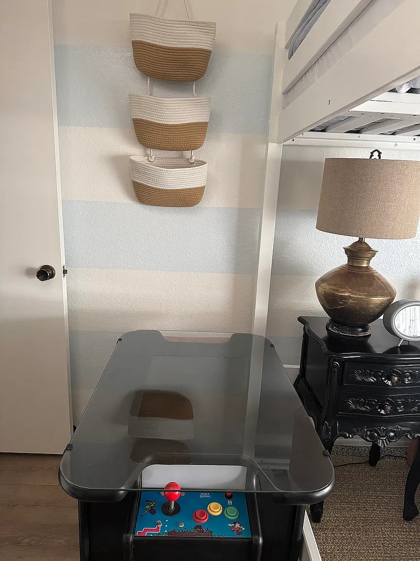 Third bedroom with full loft bed, twin bed, reading nook, and armoire. Enjoy playing video games on the video cocktail table!