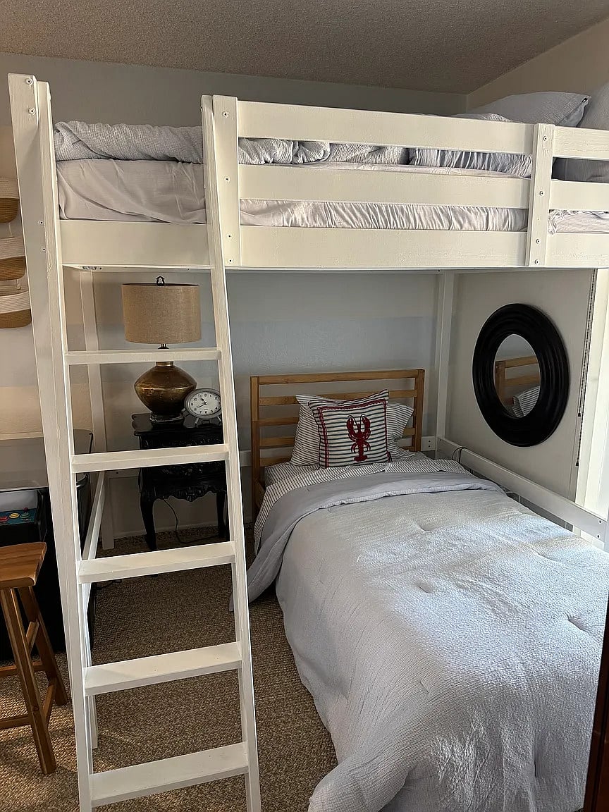 Third bedroom with full loft bed, twin bed, reading nook, and armoire. Enjoy playing video games on the video cocktail table!