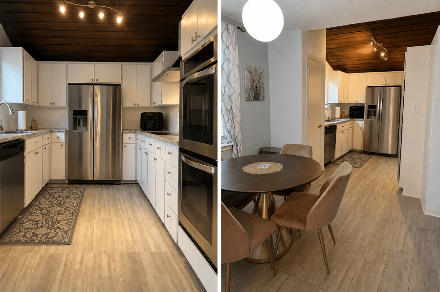 Kitchen with double oven, induction cooktop, microwave, pots, pans, plates, glassware and flatware essentials. 