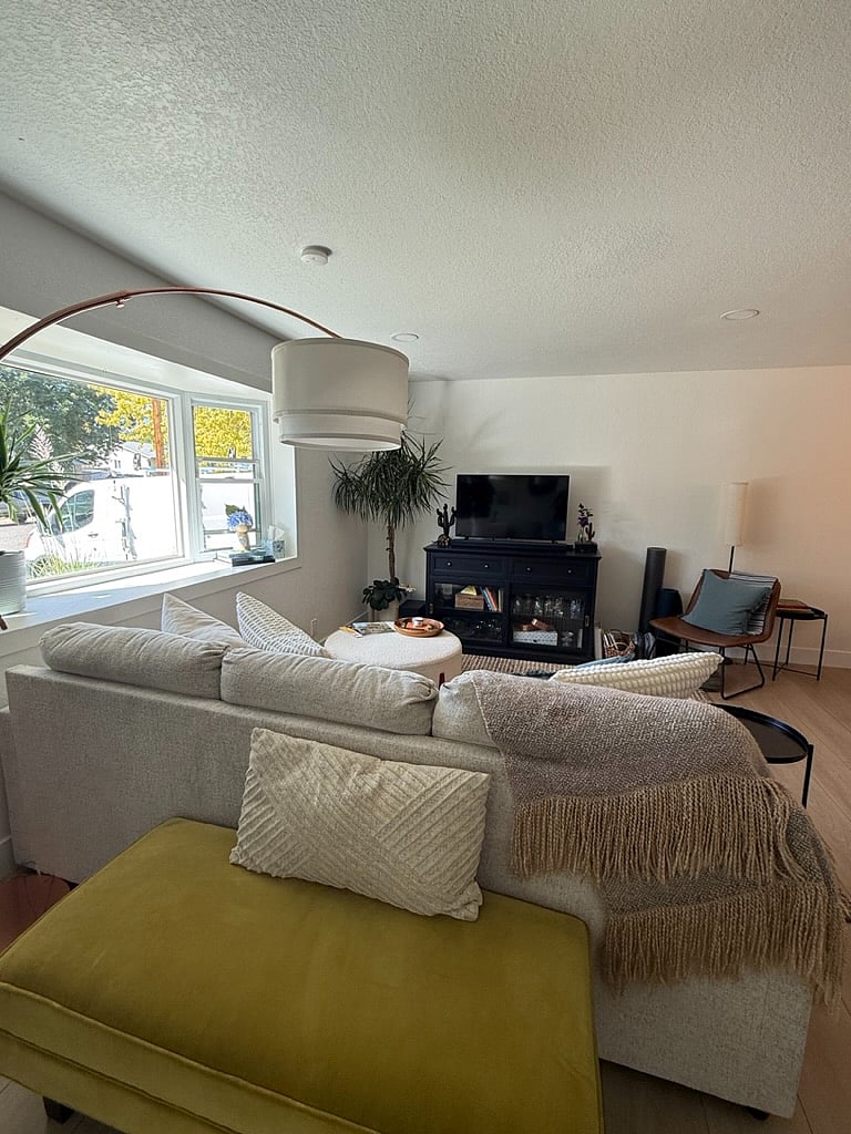Cozy living room with bay window sunshine.