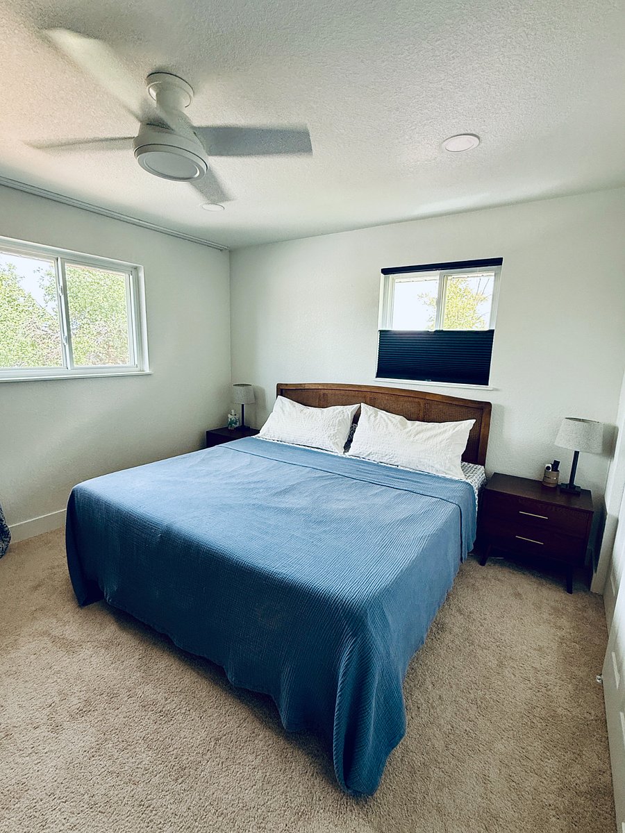 Upstairs bedroom with king memory foam bed, closets, dresser and TV.