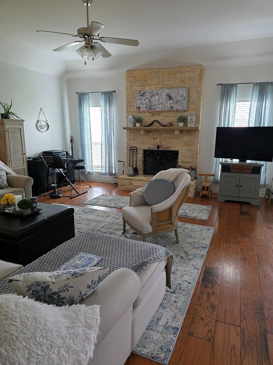 Larger Living Room with Woodburning Fireplace, second TX, Music corner, and Cozy Large sectional couch.