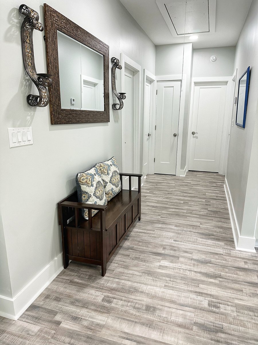 Bright interior hallway with thoughtful seating and easy access to bedrooms and baths.