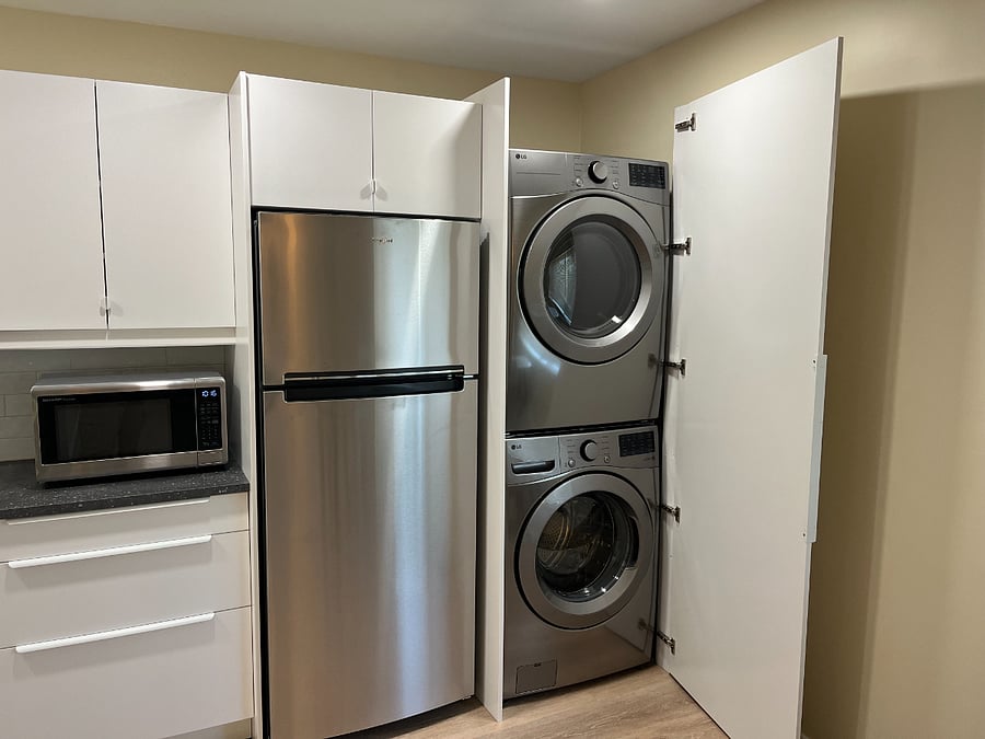 Large fridge/freezer and full-size stacked washer/dryer.