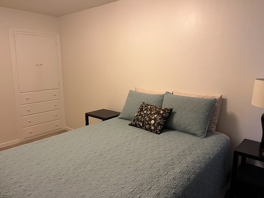 Queen bed and drawers/linen closet.