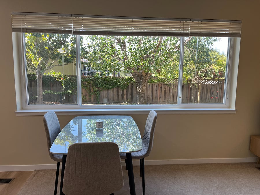 Kitchen/dining table with garden view.